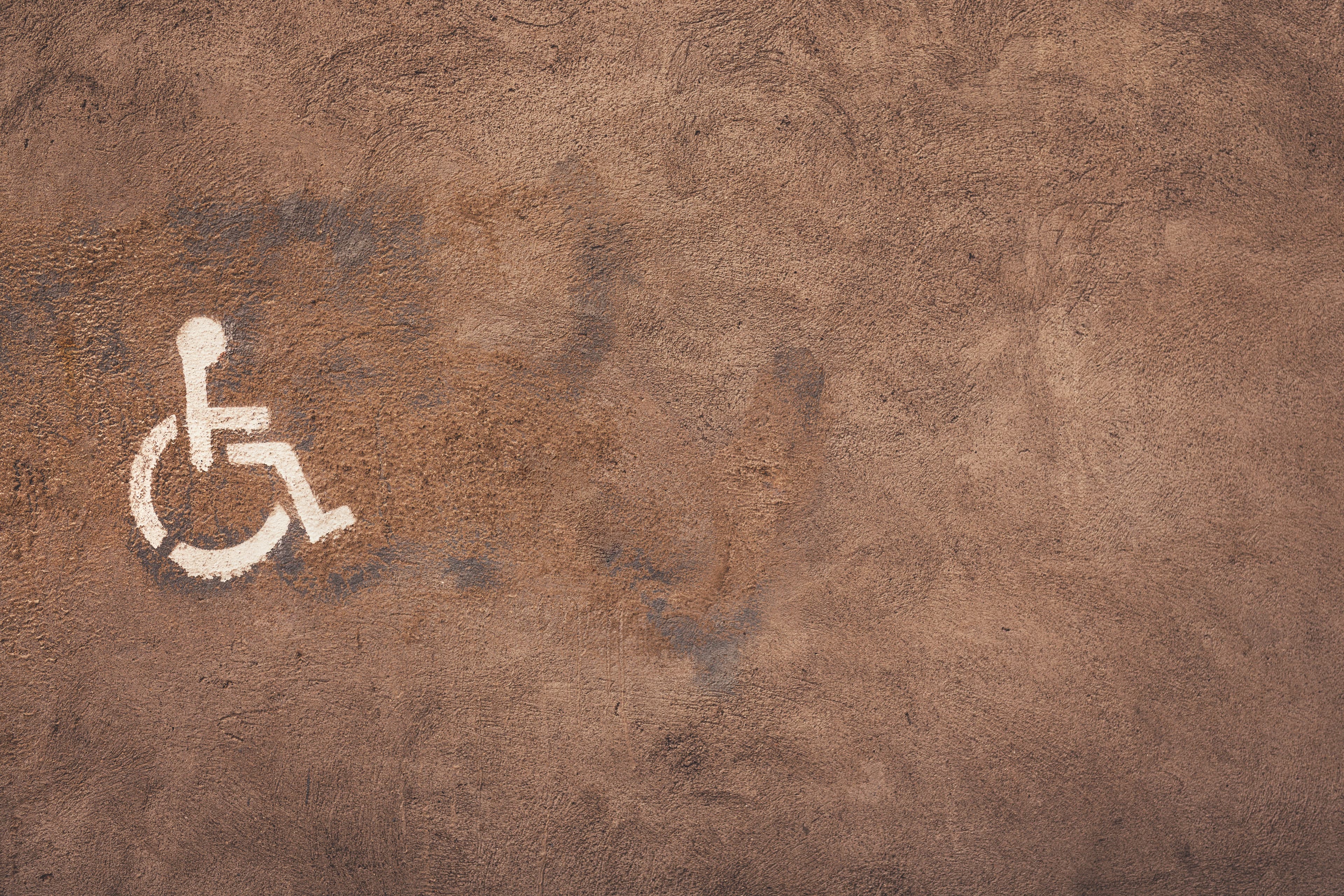 Wheelchair logo on brown textured background